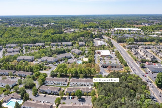 aerial view featuring a wooded view and a residential view