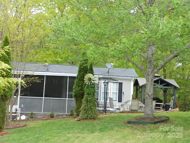 exterior space featuring a yard, a gazebo, and a sunroom