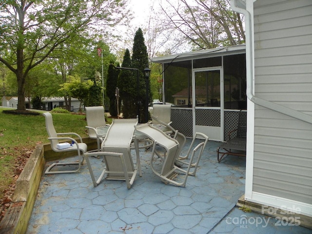 view of patio with a sunroom