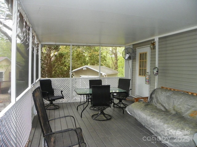 sunroom featuring outdoor dining space