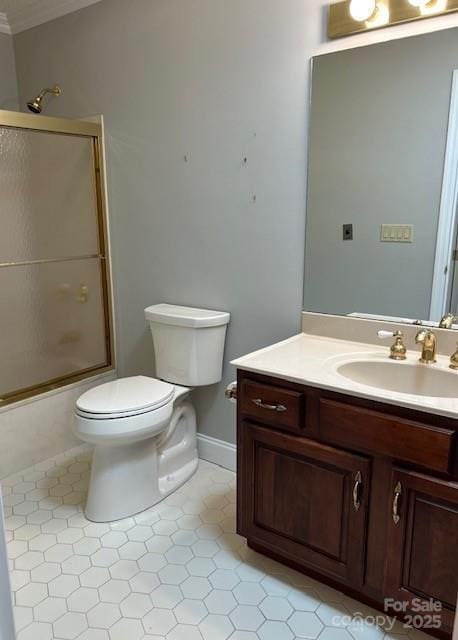 16 Ridgeview Dr, Asheville, NC 28804 - bathroom featuring crown molding, tile patterned flooring, toilet, vanity, and combined bath / shower with glass door