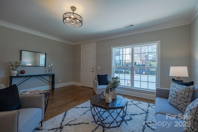 439 Beacon St NW, Concord, NC 28027 - living room featuring crown molding, wood finished floors, baseboards, and visible vents