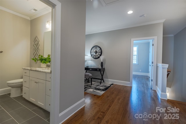 439 Beacon St NW, Concord, NC 28027 - corridor featuring dark wood-type flooring, ornamental molding, baseboards, and visible vents
