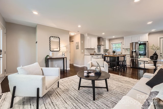 living room with recessed lighting, dark wood finished floors, and baseboards