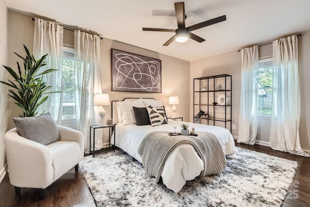 bedroom with baseboards, a ceiling fan, and wood finished floors