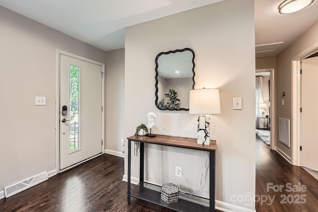 foyer featuring wood finished floors, visible vents, and baseboards