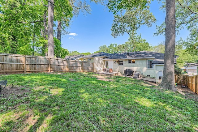 view of yard with a fenced backyard and a patio