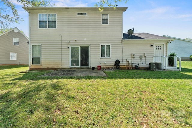 rear view of house with a yard, a patio area, and central AC