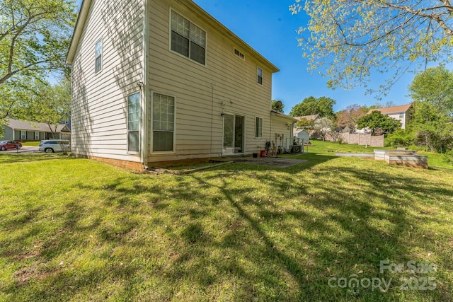 back of house featuring a yard