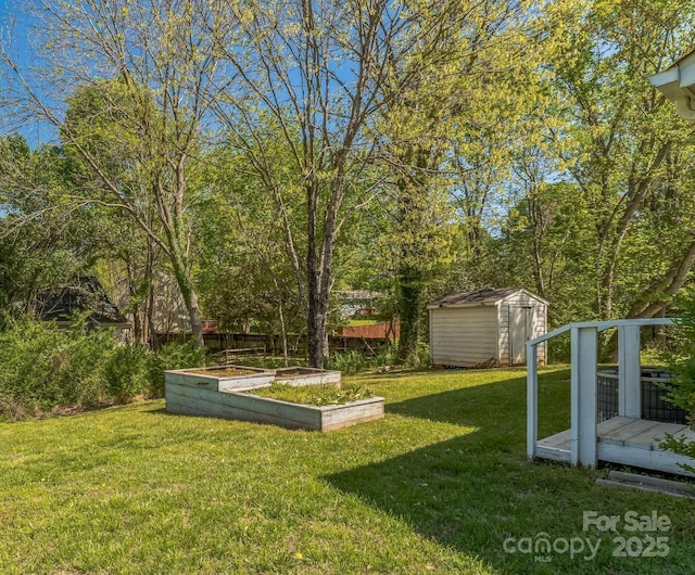 view of yard with a shed, a garden, and an outbuilding