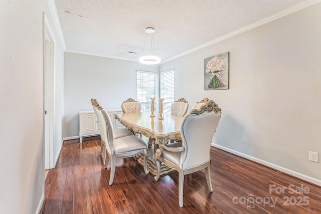 dining area featuring a textured ceiling, wood finished floors, baseboards, and ornamental molding