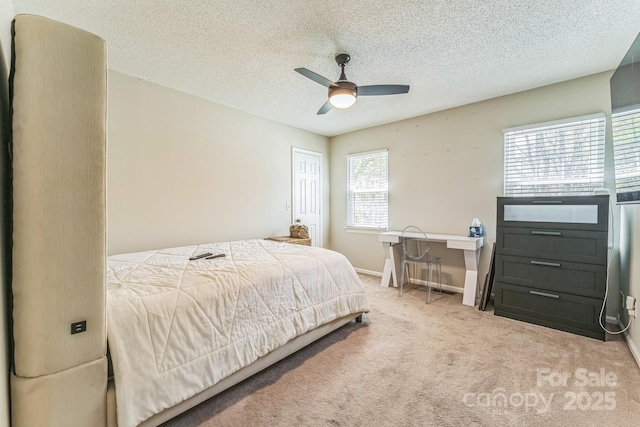 bedroom featuring baseboards, carpet flooring, ceiling fan, and a textured ceiling