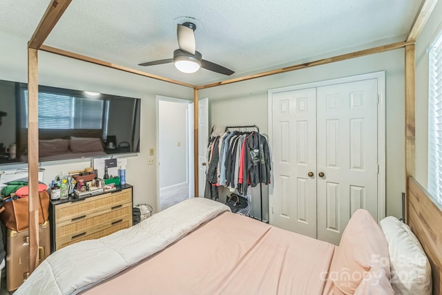 bedroom with a closet, ceiling fan, and a textured ceiling