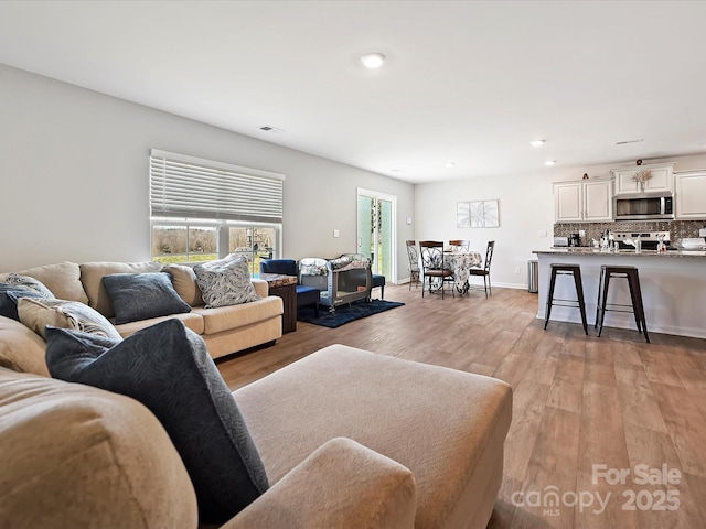 479 Daniel Dr, Lexington, NC 27295 - living room with light wood-type flooring, baseboards, visible vents, and recessed lighting