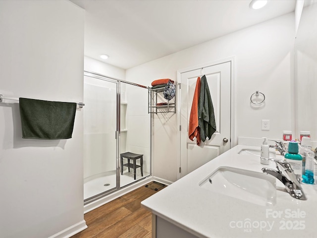 479 Daniel Dr, Lexington, NC 27295 - full bathroom with a sink, a shower stall, double vanity, and wood finished floors