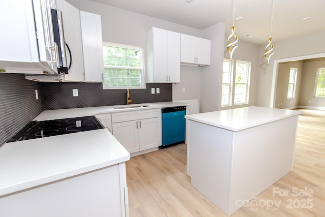2350 14th Street Ct NE, Hickory, NC 28601 - kitchen featuring dishwasher, a sink, light wood-style flooring, tasteful backsplash, and a center island