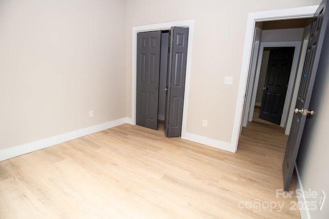 2350 14th Street Ct NE, Hickory, NC 28601 - unfurnished bedroom featuring light wood finished floors and a closet