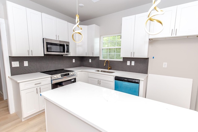2350 14th Street Ct NE, Hickory, NC 28601 - kitchen featuring stainless steel appliances, light wood finished floors, tasteful backsplash, and white cabinets