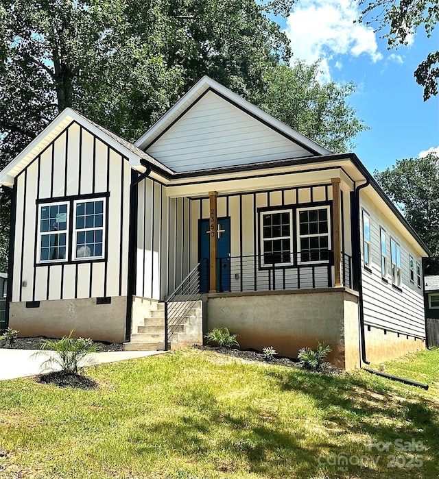 2350 14th Street Ct NE, Hickory, NC 28601 - view of front of house with crawl space, board and batten siding, a front yard, and covered porch
