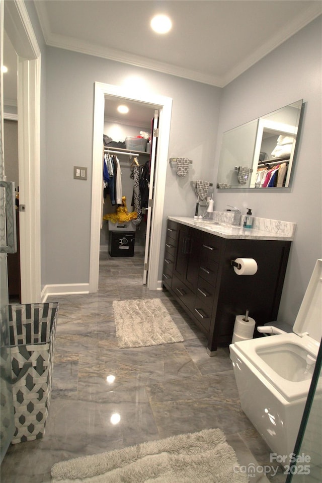 7428 Beaufort Cir, Charlotte, NC 28227 - bathroom featuring vanity, baseboards, ornamental molding, a walk in closet, and marble finish floor