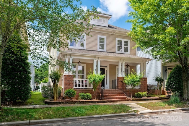 american foursquare style home with a porch