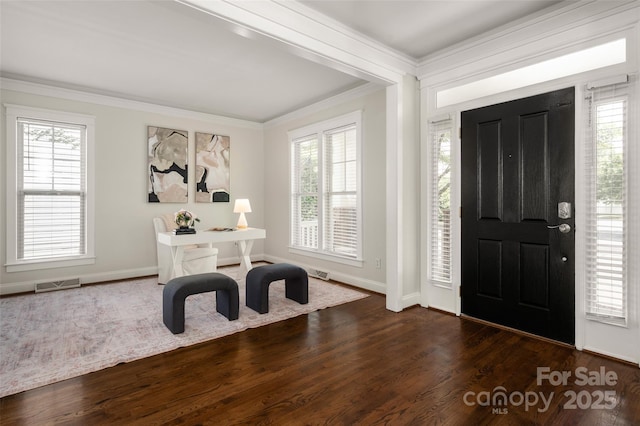 foyer featuring ornamental molding, dark wood-type flooring, and baseboards