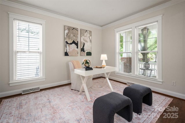 office with plenty of natural light, baseboards, ornamental molding, and wood finished floors