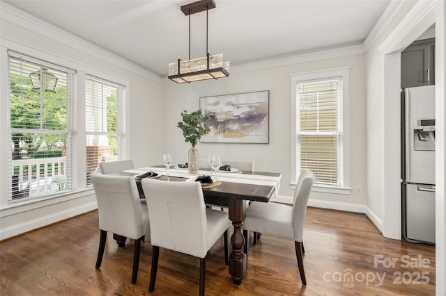 dining area featuring ornamental molding, dark wood finished floors, and baseboards