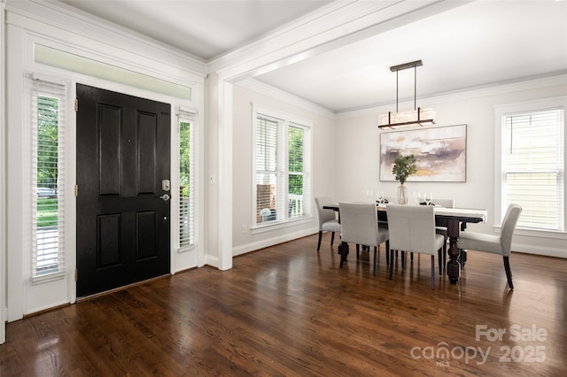 foyer entrance featuring crown molding, wood finished floors, a chandelier, and baseboards
