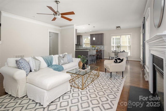 living room with a fireplace with flush hearth, wood finished floors, ceiling fan, recessed lighting, and baseboards