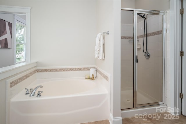 bathroom featuring a stall shower and a garden tub