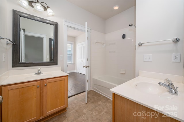 full bathroom with two vanities, shower / tub combination, and recessed lighting