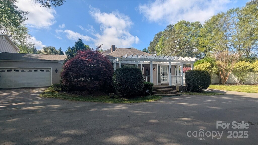 1404 Oakdale Rd, Rock Hill, SC 29730 - view of front of house featuring a pergola and aphalt driveway