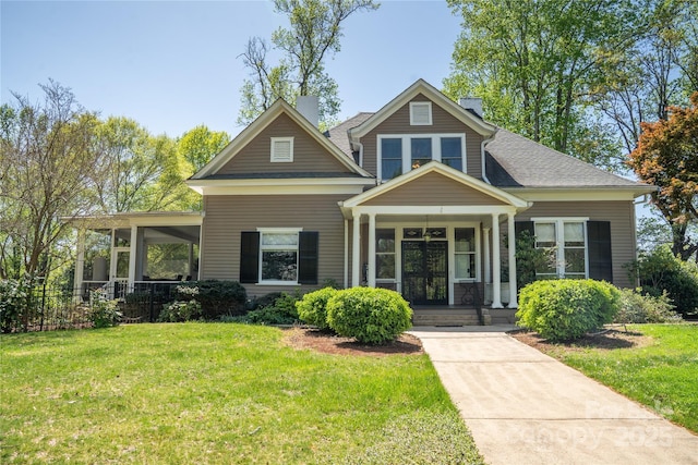 447 N Washington St, Rutherfordton, NC 28139 - craftsman-style home with a shingled roof, a chimney, and a front lawn