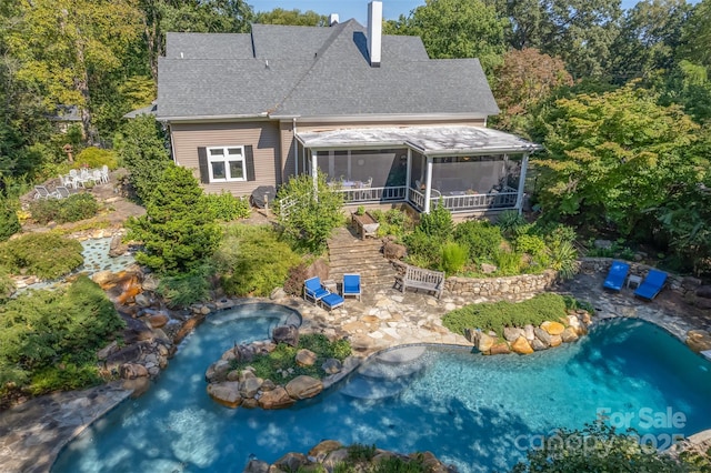 447 N Washington St, Rutherfordton, NC 28139 - back of property featuring a patio area, an outdoor pool, a sunroom, and a shingled roof