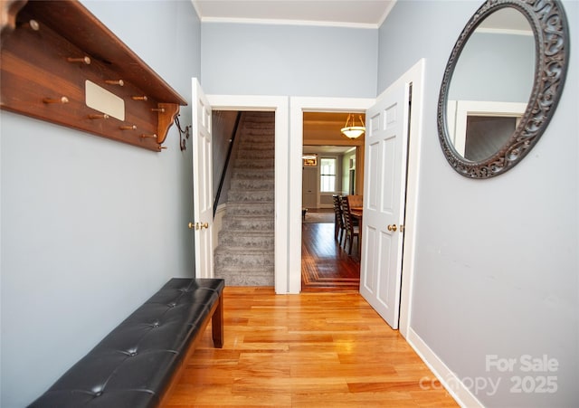 447 N Washington St, Rutherfordton, NC 28139 - hallway with crown molding, light wood finished floors, and stairway