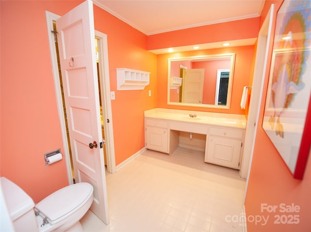 447 N Washington St, Rutherfordton, NC 28139 - bathroom with vanity, baseboards, crown molding, and toilet