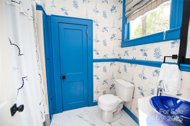 447 N Washington St, Rutherfordton, NC 28139 - bathroom with toilet, marble finish floor, and wallpapered walls