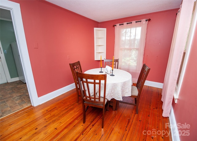 447 N Washington St, Rutherfordton, NC 28139 - dining space with crown molding, wood-type flooring, and baseboards