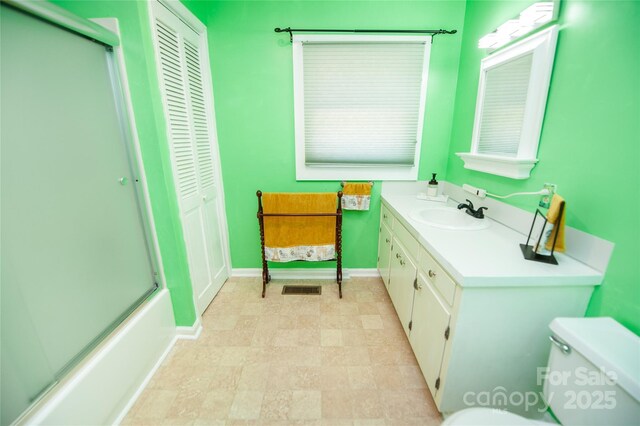 447 N Washington St, Rutherfordton, NC 28139 - bathroom with a closet, baseboards, toilet, vanity, and a shower with door