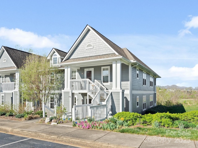 view of front of property featuring stairs and covered porch