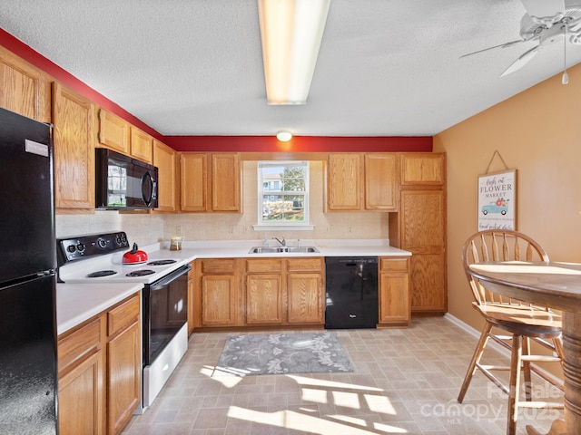 kitchen featuring a sink, black appliances, a ceiling fan, and a textured ceiling