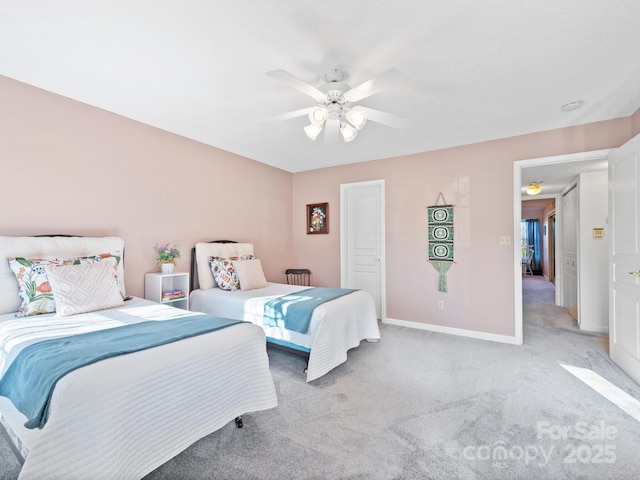 bedroom with light carpet, baseboards, and a ceiling fan