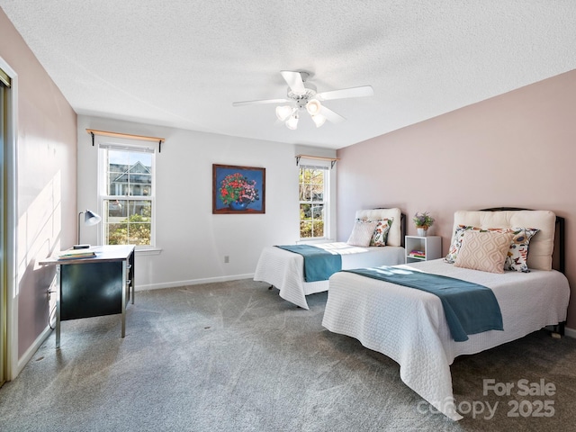 carpeted bedroom featuring a textured ceiling, ceiling fan, and baseboards