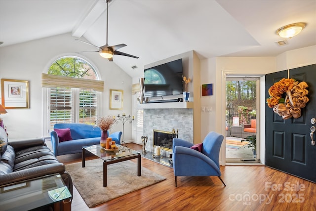 7444 Hurstbourne Green Dr, Charlotte, NC 28277 - living room featuring wood finished floors, ceiling fan, lofted ceiling with beams, and a wealth of natural light
