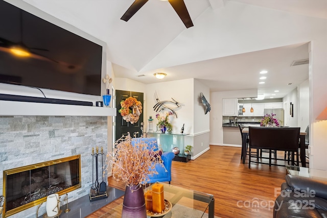 7444 Hurstbourne Green Dr, Charlotte, NC 28277 - living room with ceiling fan, a fireplace, vaulted ceiling, wood finished floors, and baseboards