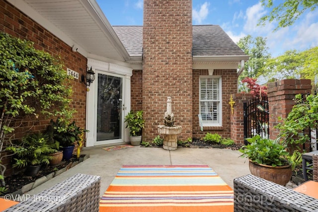 7444 Hurstbourne Green Dr, Charlotte, NC 28277 - entrance to property with brick siding, a shingled roof, a patio area, and a gate