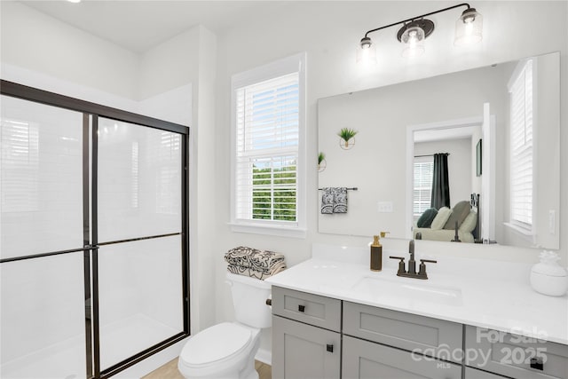 full bathroom with a shower stall, toilet, and vanity