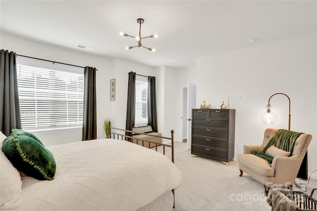 bedroom featuring a chandelier, visible vents, and light carpet