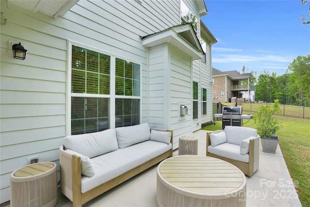 view of patio / terrace with grilling area, fence, and an outdoor living space